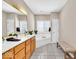 Bright bathroom with double vanity, soaking tub under window, and tiled floor at 8717 Vintner Ct, Indianapolis, IN 46256