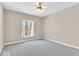 Spacious bedroom with neutral carpet and a window overlooking outdoor scenery at 8717 Vintner Ct, Indianapolis, IN 46256