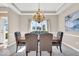 Dining area featuring a modern chandelier, tray ceiling, and comfortable seating at 8717 Vintner Ct, Indianapolis, IN 46256