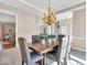 Elegant dining room featuring a tray ceiling, chandelier, and an adjacent living area at 8717 Vintner Ct, Indianapolis, IN 46256