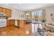 Open kitchen with wood cabinets, a hardwood floor, eat-in area, and sliding glass door to the deck at 8717 Vintner Ct, Indianapolis, IN 46256