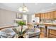 Kitchen and dining area with hardwood floors, wood cabinetry, and seating for four at 8717 Vintner Ct, Indianapolis, IN 46256
