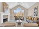 Inviting living room with a fireplace, vaulted ceilings, and ample natural light at 8717 Vintner Ct, Indianapolis, IN 46256