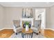 Cozy living room with a fireplace, two chairs, neutral paint and hardwood floors at 8717 Vintner Ct, Indianapolis, IN 46256