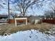 Backyard with wooden fence, shed, tree, grass and snow at 8738 Montery Ct, Indianapolis, IN 46226