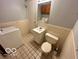 Cozy bathroom featuring a toilet, washer, vanity with a single sink, and a mirrored cabinet at 8738 Montery Ct, Indianapolis, IN 46226