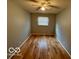 Comfortable bedroom with hardwood flooring, neutral walls, ceiling fan, and lots of natural light at 8738 Montery Ct, Indianapolis, IN 46226