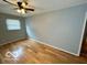 Well-lit bedroom featuring hardwood floors, neutral walls, a ceiling fan and a window with blinds at 8738 Montery Ct, Indianapolis, IN 46226