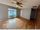 Comfortable living room with hardwood floors, neutral gray walls, and large window for natural light at 8738 Montery Ct, Indianapolis, IN 46226