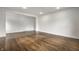 Finished basement area with hardwood floors, bright lighting, and neutral decor at 8888 Cholla Rd, Indianapolis, IN 46240