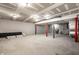 Unfinished basement with concrete floors, exposed pipes, and bright lighting at 8888 Cholla Rd, Indianapolis, IN 46240