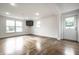 Spacious basement area with hardwood floors, bright lighting, and an outdoor view from the windows at 8888 Cholla Rd, Indianapolis, IN 46240