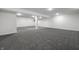 Finished basement area with gray carpet, bright lighting, and neutral decor at 8888 Cholla Rd, Indianapolis, IN 46240