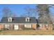 Charming single-story brick home with dormer windows, shutters, well-manicured lawn, and a classic double door entry at 8888 Cholla Rd, Indianapolis, IN 46240