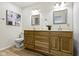 Bathroom featuring a double vanity, framed mirrors, and contemporary fixtures at 9788 Pine Ridge North Dr, Fishers, IN 46038