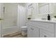 Well-lit bathroom with white vanity, tub/shower and laminate flooring at 9788 Pine Ridge North Dr, Fishers, IN 46038