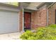 Close-up of the front door and brick facade, highlighting the entrance and attached garage at 9788 Pine Ridge North Dr, Fishers, IN 46038
