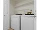 Convenient laundry area with a washer and dryer, plus overhead shelving at 9788 Pine Ridge North Dr, Fishers, IN 46038