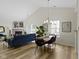 Bright living room with a vaulted ceiling, fireplace, wood floors, and modern decor at 9788 Pine Ridge North Dr, Fishers, IN 46038