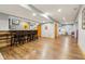 Finished basement featuring a bar with seating, wood floors, and recessed lighting at 9956 Hickory Ridge Dr, Zionsville, IN 46077