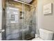 Bathroom with walk-in shower, tiled walls, and tiled floor, toilet, and decorative hanging at 9956 Hickory Ridge Dr, Zionsville, IN 46077