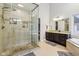 This bathroom features a glass shower and a vanity with dark wood cabinets and granite countertops at 9956 Hickory Ridge Dr, Zionsville, IN 46077