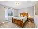This bedroom has carpet and a window with a wood-framed bed and matching side tables at 9956 Hickory Ridge Dr, Zionsville, IN 46077