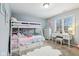Charming bedroom featuring a bunk bed, desk, plush rug, and plenty of natural light at 9956 Hickory Ridge Dr, Zionsville, IN 46077
