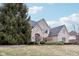 Inviting brick home with arched doorway, lush lawn and mature landscaping at 9956 Hickory Ridge Dr, Zionsville, IN 46077