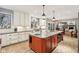 Open kitchen with brick floors, a large island, pendant lighting, and stainless appliances at 9956 Hickory Ridge Dr, Zionsville, IN 46077