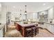 Open kitchen featuring brick floors, a large island with seating, and stainless steel appliances at 9956 Hickory Ridge Dr, Zionsville, IN 46077