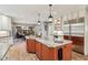 Spacious kitchen featuring a large island, brick floors, and stainless steel appliances at 9956 Hickory Ridge Dr, Zionsville, IN 46077