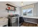 This laundry room features stainless steel washer/dryer, plenty of storage and counter space for folding laundry at 9956 Hickory Ridge Dr, Zionsville, IN 46077