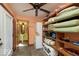 A brightly painted laundry room with a washer/dryer, shelving, and access to the bathroom at 9956 Hickory Ridge Dr, Zionsville, IN 46077