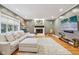 Comfortable living room with large sectional sofa, fireplace and hardwood flooring at 9956 Hickory Ridge Dr, Zionsville, IN 46077