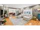 Comfortable living room features a neutral sectional sofa and hardwood floors at 9956 Hickory Ridge Dr, Zionsville, IN 46077