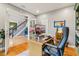 Office space features a desk, chair, and views into the foyer and staircase at 9956 Hickory Ridge Dr, Zionsville, IN 46077