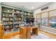 Bright office featuring a large bookcase wall and natural light from a window at 9956 Hickory Ridge Dr, Zionsville, IN 46077