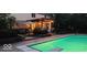 A beautiful inground pool with an adjacent pergola-covered patio with outdoor lighting, and a diving board at 9956 Hickory Ridge Dr, Zionsville, IN 46077