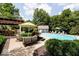 An inviting pool with a cabana, outdoor seating and bar under a pergola in a lush backyard at 9956 Hickory Ridge Dr, Zionsville, IN 46077