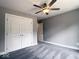 This bedroom features neutral walls, carpet, a ceiling fan, and a large closet with white double doors at 103 N Brenrich Rd, Pendleton, IN 46064