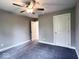 Neutral bedroom with ceiling fan, carpet, and doors at 103 N Brenrich Rd, Pendleton, IN 46064