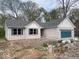 Exterior of home featuring a garage with blue door, a lawn and brick exterior at 103 N Brenrich Rd, Pendleton, IN 46064