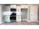Kitchen with white cabinets, white subway tile backsplash, and stainless steel appliances at 103 N Brenrich Rd, Pendleton, IN 46064
