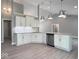 An open concept kitchen offers gray walls, white cabinets, and stainless appliances at 103 N Brenrich Rd, Pendleton, IN 46064
