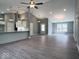 Open-concept living area with gray walls, gray-toned floors, and vaulted ceiling at 103 N Brenrich Rd, Pendleton, IN 46064