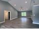 Spacious living room with gray walls, gray-toned floors, and vaulted ceiling at 103 N Brenrich Rd, Pendleton, IN 46064