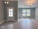 Bright living room features hardwood floors, a large window, and stylish light fixtures at 103 N Brenrich Rd, Pendleton, IN 46064