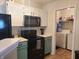 Efficient kitchen layout with modern appliances, ample storage, and a convenient laundry area, designed for effortless meal preparation at 10921 Walnut Grv, Camby, IN 46113