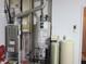 A home's efficient utility room contains a water heater, water softener, and Carrier heating system at 10921 Walnut Grv, Camby, IN 46113